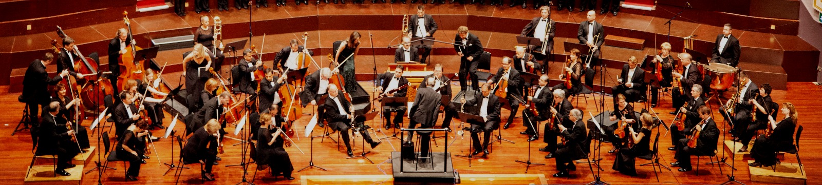 an orchestra on a stage between performances